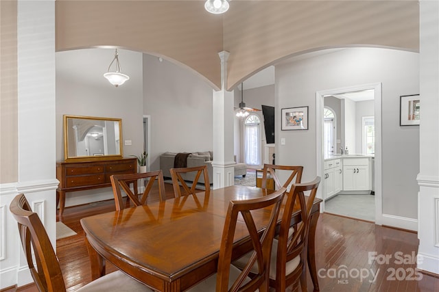 4605 Sarandon Ct, Charlotte, NC 28215 - dining room with arched walkways, ornate columns, hardwood / wood-style flooring, ceiling fan, and vaulted ceiling