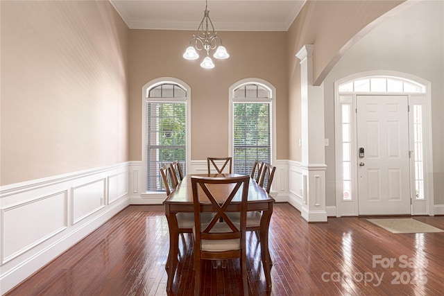 4605 Sarandon Ct, Charlotte, NC 28215 - dining room featuring arched walkways, a chandelier, dark wood-type flooring, wainscoting, and a decorative wall