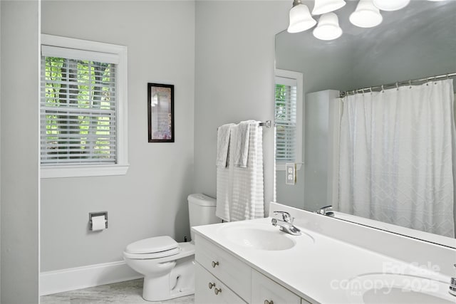 4605 Sarandon Ct, Charlotte, NC 28215 - bathroom with double vanity, a chandelier, and marble look tiles