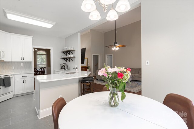 4605 Sarandon Ct, Charlotte, NC 28215 - dining space featuring a chandelier, ceiling fan, and light tile patterned flooring