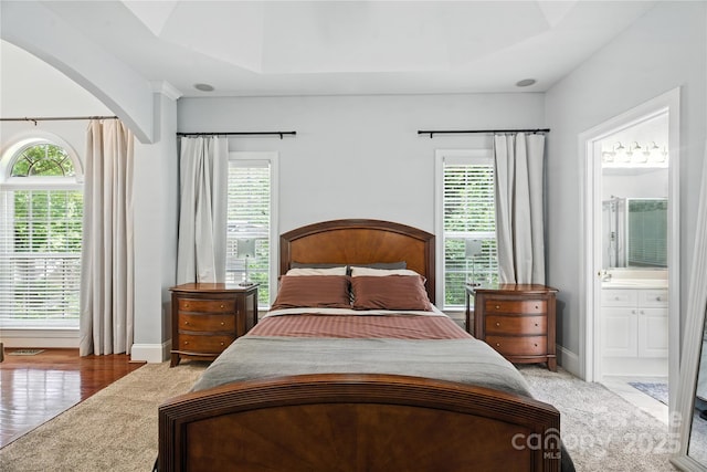 4605 Sarandon Ct, Charlotte, NC 28215 - bedroom featuring arched walkways, ensuite bath, and light wood-type flooring