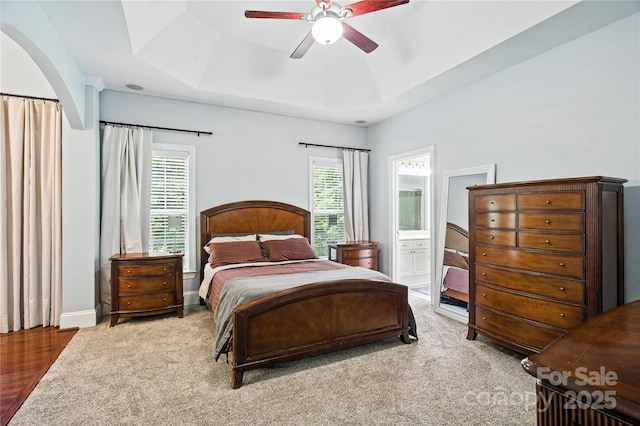 4605 Sarandon Ct, Charlotte, NC 28215 - bedroom with a tray ceiling, ensuite bathroom, carpet floors, and a ceiling fan