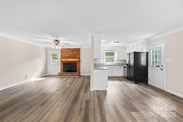 13715 Mayes Rd, Huntersville, NC 28078 - kitchen with black fridge with ice dispenser, open floor plan, ornamental molding, white cabinetry, and ceiling fan