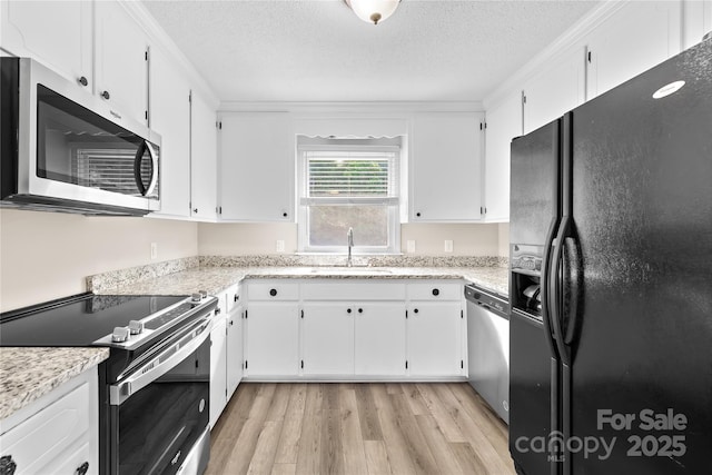 13715 Mayes Rd, Huntersville, NC 28078 - kitchen featuring stainless steel appliances, light wood-style flooring, a textured ceiling, and white cabinetry