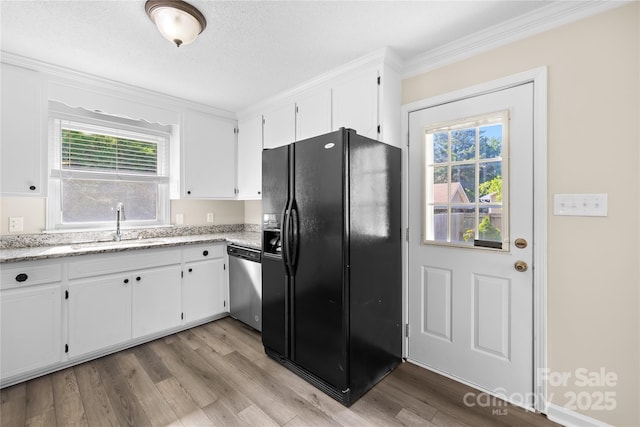 13715 Mayes Rd, Huntersville, NC 28078 - kitchen with black fridge, dishwasher, white cabinets, light wood-style flooring, and ornamental molding