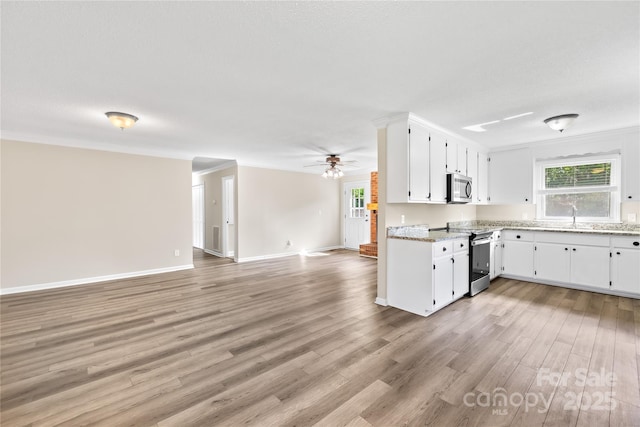 13715 Mayes Rd, Huntersville, NC 28078 - kitchen with appliances with stainless steel finishes, open floor plan, light wood finished floors, white cabinetry, and ceiling fan