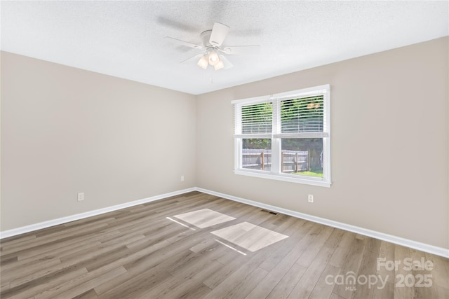13715 Mayes Rd, Huntersville, NC 28078 - unfurnished room featuring wood finished floors, ceiling fan, and a textured ceiling