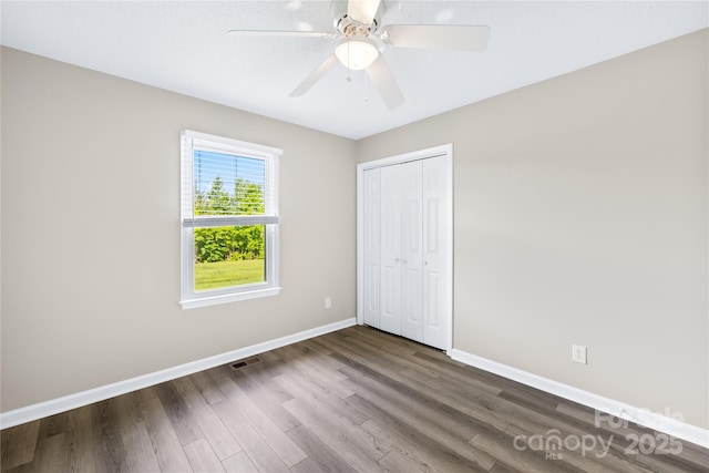 13715 Mayes Rd, Huntersville, NC 28078 - unfurnished bedroom featuring dark wood-style floors, a closet, and a ceiling fan