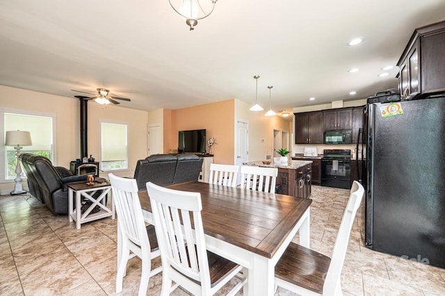 3659 Vashti Rd, Taylorsville, NC 28681 - dining room featuring ceiling fan, a wood stove, and recessed lighting