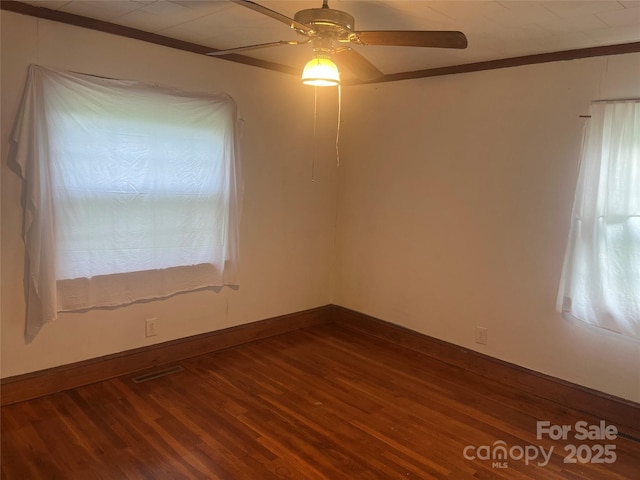 9314 Seymour Ln, Davidson, NC 28036 - empty room featuring dark wood finished floors, ceiling fan, and ornamental molding