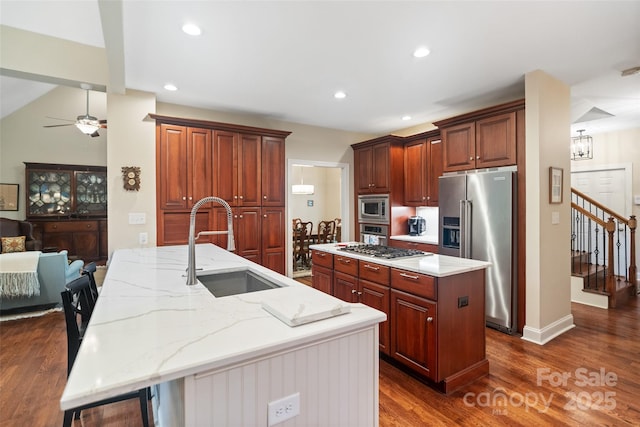 23 Tanglewood Rd, Clover, SC 29710 - kitchen with stainless steel appliances, a kitchen island with sink, dark wood finished floors, light stone counters, and a ceiling fan