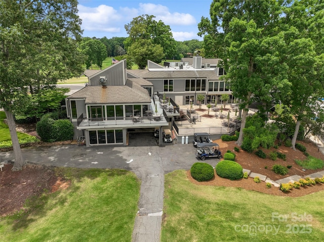 23 Tanglewood Rd, Clover, SC 29710 - back of property featuring roof with shingles, stairs, a chimney, and asphalt driveway