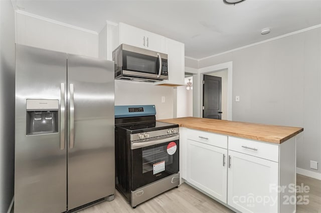 210 Marshall St, Rock Hill, SC 29730 - kitchen featuring appliances with stainless steel finishes, wood counters, ornamental molding, a peninsula, and white cabinets