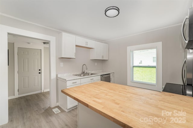 210 Marshall St, Rock Hill, SC 29730 - kitchen featuring butcher block counters, appliances with stainless steel finishes, white cabinetry, light wood-type flooring, and a peninsula