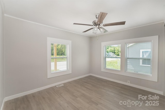 210 Marshall St, Rock Hill, SC 29730 - empty room featuring healthy amount of natural light, wood finished floors, crown molding, and a ceiling fan