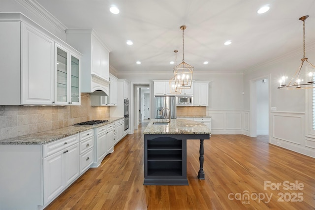 20635 Queensdale Dr, Cornelius, NC 28031 - kitchen with a chandelier, stainless steel appliances, white cabinetry, wine cooler, and recessed lighting