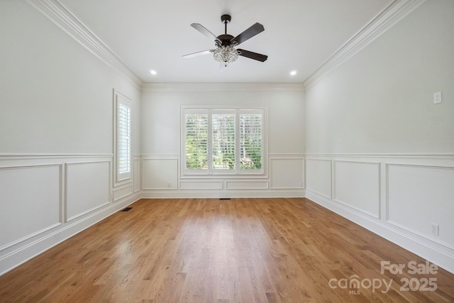 20635 Queensdale Dr, Cornelius, NC 28031 - unfurnished room featuring ceiling fan, light wood-style floors, crown molding, a wainscoted wall, and recessed lighting
