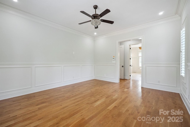 20635 Queensdale Dr, Cornelius, NC 28031 - spare room featuring a ceiling fan, a decorative wall, ornamental molding, light wood finished floors, and a wainscoted wall