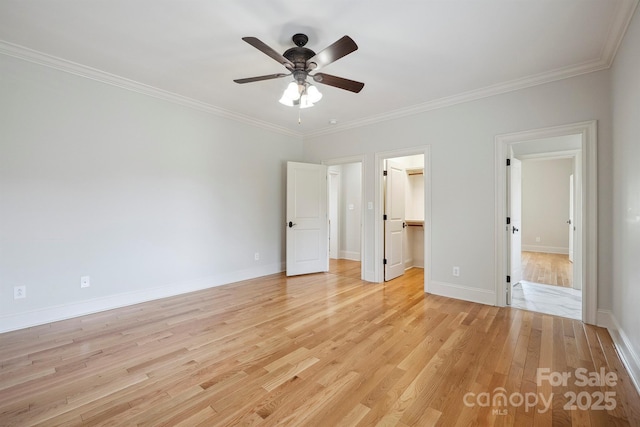 20635 Queensdale Dr, Cornelius, NC 28031 - unfurnished bedroom with light wood finished floors, ornamental molding, a walk in closet, a ceiling fan, and a closet