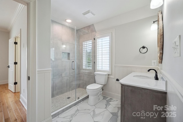 20635 Queensdale Dr, Cornelius, NC 28031 - full bathroom featuring ornamental molding, vanity, a stall shower, a wainscoted wall, and a decorative wall