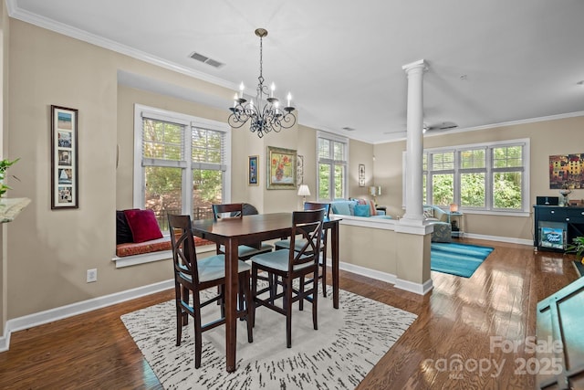 4854 S Hill View Dr, Charlotte, NC 28210 - dining area with decorative columns, ornamental molding, wood finished floors, and a chandelier