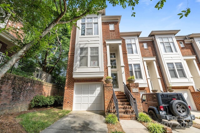 4854 S Hill View Dr, Charlotte, NC 28210 - view of property featuring a garage, brick siding, and driveway