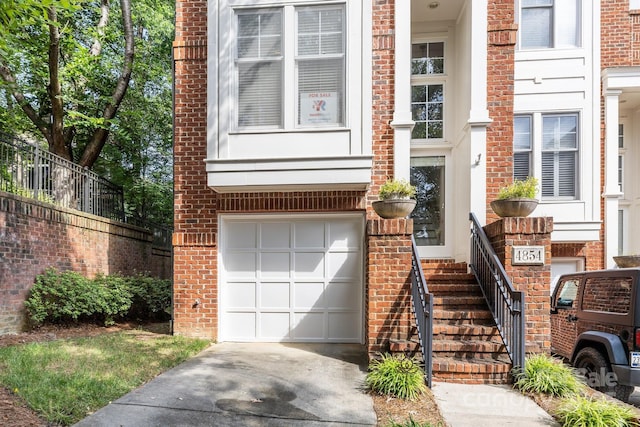 4854 S Hill View Dr, Charlotte, NC 28210 - doorway to property with driveway, an attached garage, and brick siding