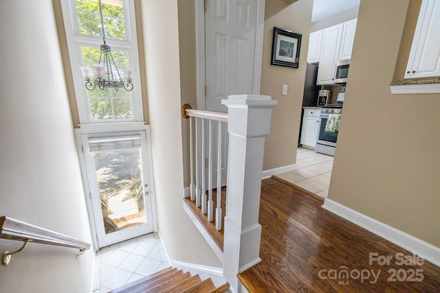 4854 S Hill View Dr, Charlotte, NC 28210 - staircase with a chandelier and tile patterned floors