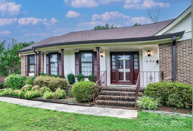1658 Buckingham Ave, Gastonia, NC 28054 - view of exterior entry featuring brick siding, covered porch, and roof with shingles