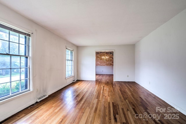 1658 Buckingham Ave, Gastonia, NC 28054 - empty room featuring healthy amount of natural light and wood finished floors