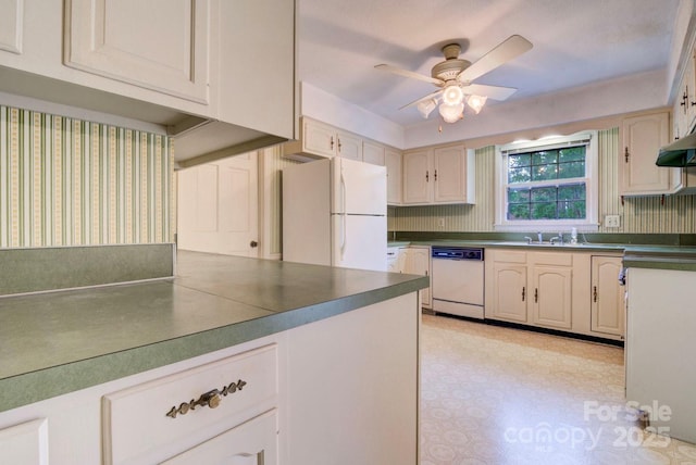 1658 Buckingham Ave, Gastonia, NC 28054 - kitchen with white appliances, a ceiling fan, dark countertops, light floors, and wallpapered walls