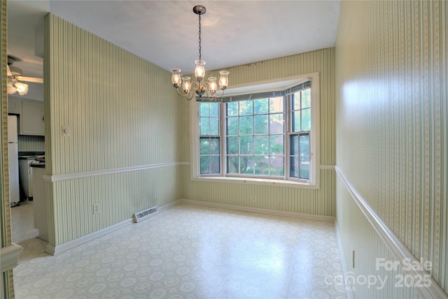 1658 Buckingham Ave, Gastonia, NC 28054 - unfurnished room with a chandelier, plenty of natural light, and wallpapered walls