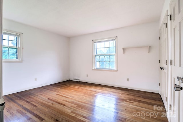 1658 Buckingham Ave, Gastonia, NC 28054 - unfurnished room featuring healthy amount of natural light and wood finished floors