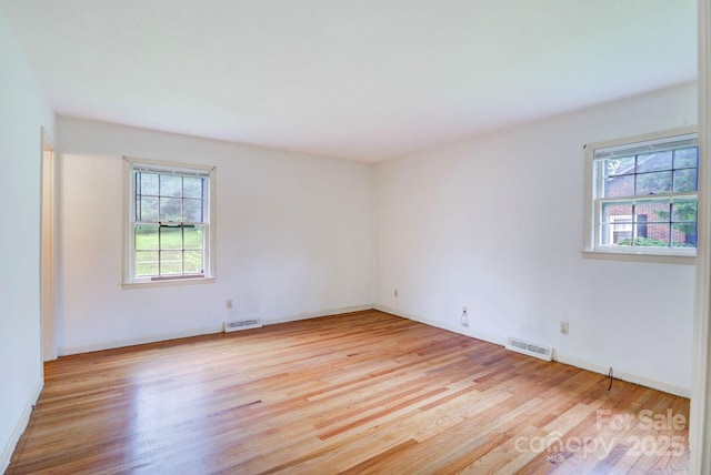 1658 Buckingham Ave, Gastonia, NC 28054 - empty room with plenty of natural light and light wood-style floors