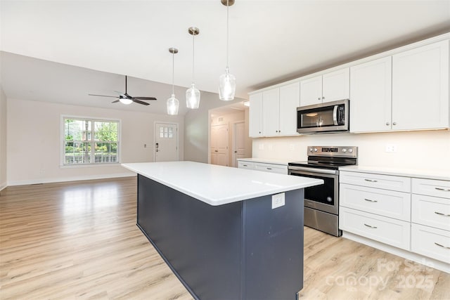 43 Paddington Dr SW, Concord, NC 28025 - kitchen featuring appliances with stainless steel finishes, light wood-style flooring, a center island, a ceiling fan, and white cabinetry