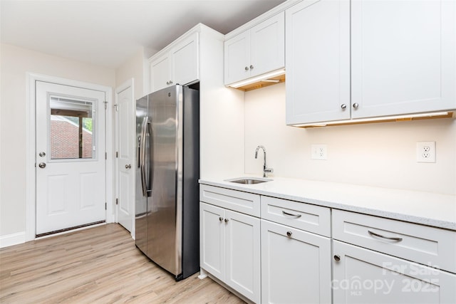 43 Paddington Dr SW, Concord, NC 28025 - kitchen with stainless steel refrigerator with ice dispenser, light countertops, light wood-type flooring, and white cabinetry