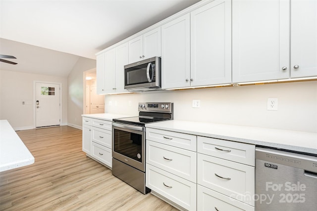 43 Paddington Dr SW, Concord, NC 28025 - kitchen with stainless steel appliances, light wood-style flooring, light countertops, and lofted ceiling
