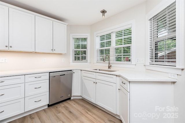 43 Paddington Dr SW, Concord, NC 28025 - kitchen with dishwasher, healthy amount of natural light, light wood finished floors, and white cabinetry