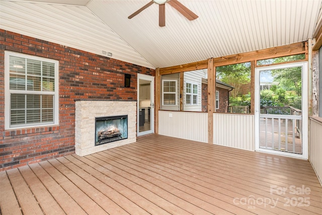 43 Paddington Dr SW, Concord, NC 28025 - unfurnished sunroom featuring a lit fireplace, lofted ceiling, and a ceiling fan