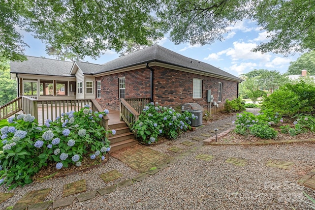 43 Paddington Dr SW, Concord, NC 28025 - rear view of property with brick siding, a deck, and roof with shingles