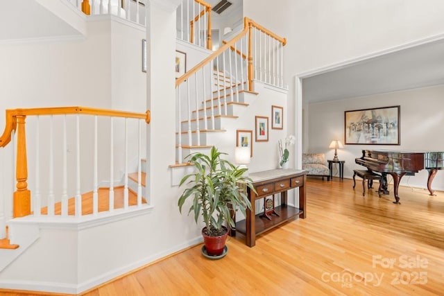 9514 Hayenridge Ct, Huntersville, NC 28078 - staircase featuring wood finished floors, a towering ceiling, and crown molding