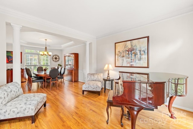 9514 Hayenridge Ct, Huntersville, NC 28078 - sitting room with ornate columns, a chandelier, wood finished floors, ornamental molding, and a raised ceiling