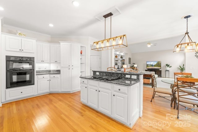 9514 Hayenridge Ct, Huntersville, NC 28078 - kitchen featuring black appliances, light wood finished floors, a kitchen island, white cabinetry, and ornamental molding