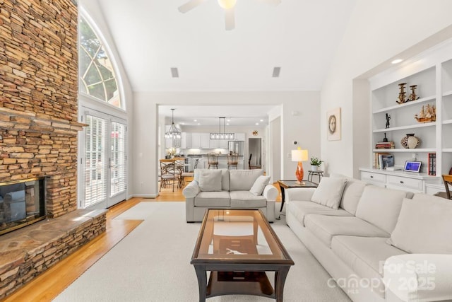 9514 Hayenridge Ct, Huntersville, NC 28078 - living room with high vaulted ceiling, a fireplace, light wood-style floors, and a ceiling fan