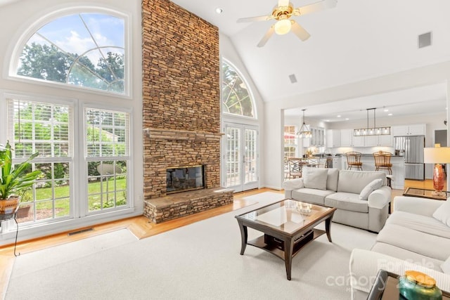 9514 Hayenridge Ct, Huntersville, NC 28078 - living room featuring high vaulted ceiling, a ceiling fan, light wood-type flooring, a fireplace, and recessed lighting