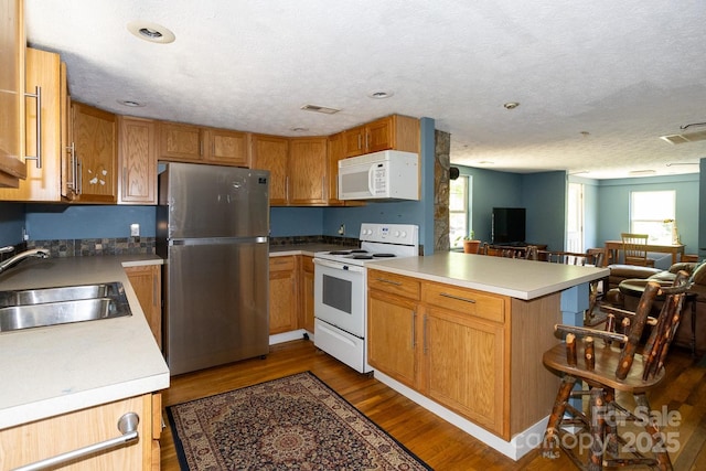 3153 US-70 Hwy E, Black Mountain, NC 28711 - kitchen with white appliances, a peninsula, open floor plan, dark wood-type flooring, and light countertops