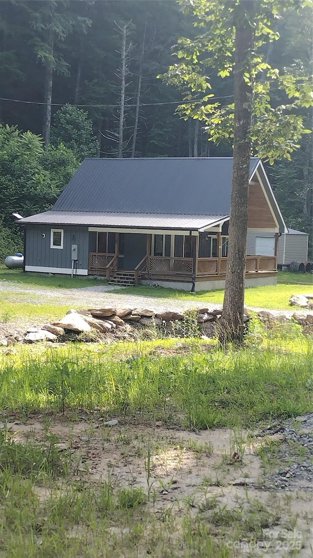 962 Laurel Mountain View Rd, Flat Rock, NC 28731 - view of front of house featuring covered porch, a metal roof, and board and batten siding