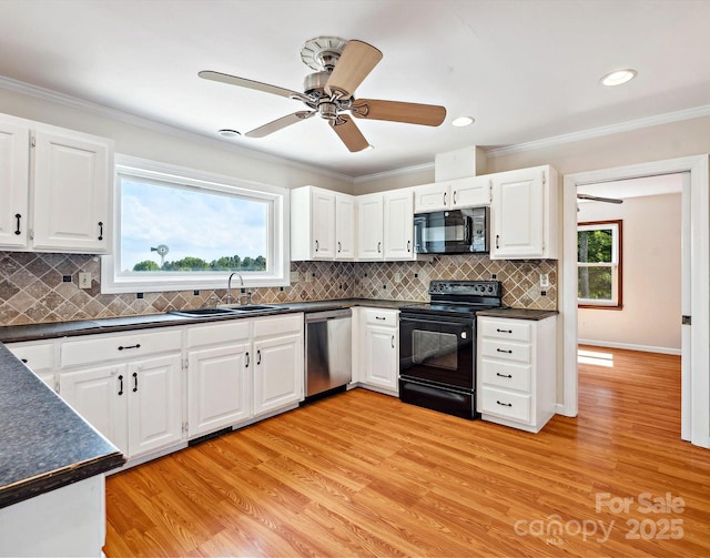 5632 Zion Church Rd, Concord, NC 28025 - kitchen featuring black appliances, dark countertops, light wood finished floors, white cabinets, and ornamental molding