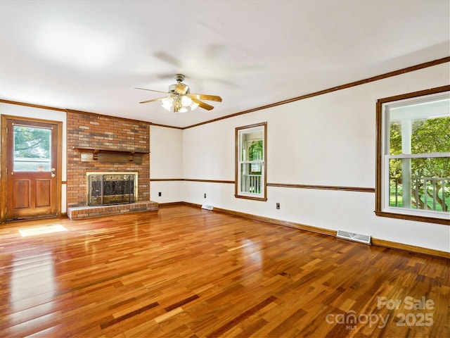 5632 Zion Church Rd, Concord, NC 28025 - unfurnished living room featuring wood finished floors, ceiling fan, a fireplace, and crown molding