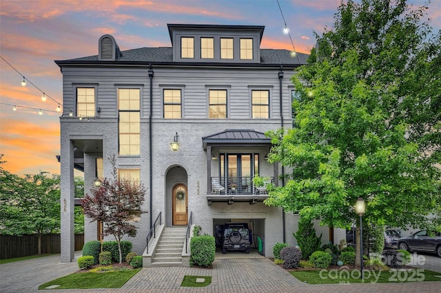 622 Mattie Rose Ln, Charlotte, NC 28204 - view of front facade featuring a balcony, decorative driveway, a shingled roof, and a chimney
